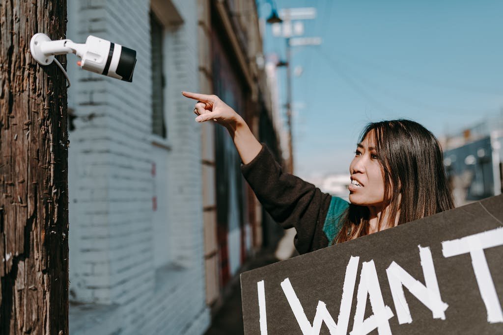 A Woman Pointing a Cctv