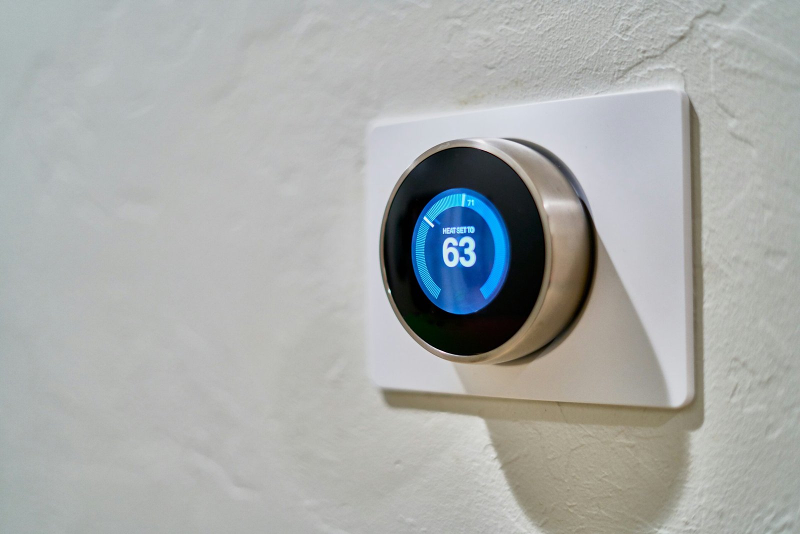 Smart Cities: The Intersection of Technology and Urban Living 5 gray Nest thermostat displaying at 63